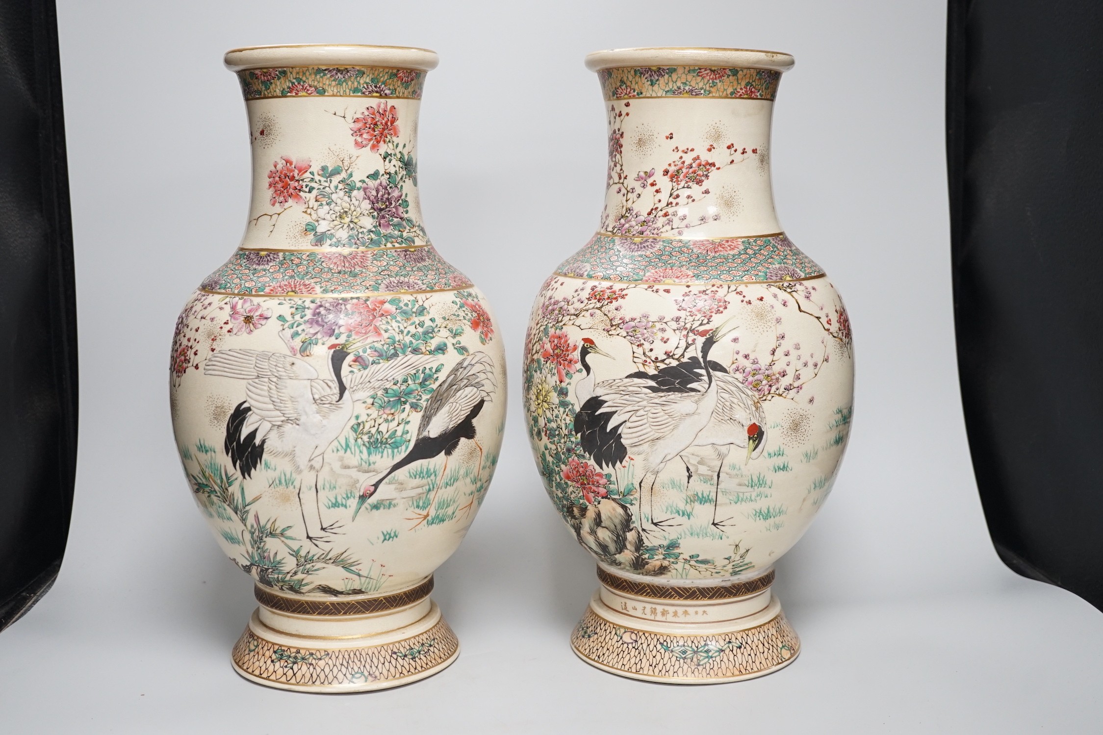A pair of Japanese Satsuma pottery vases, Meiji period signed above foot, height 38cm